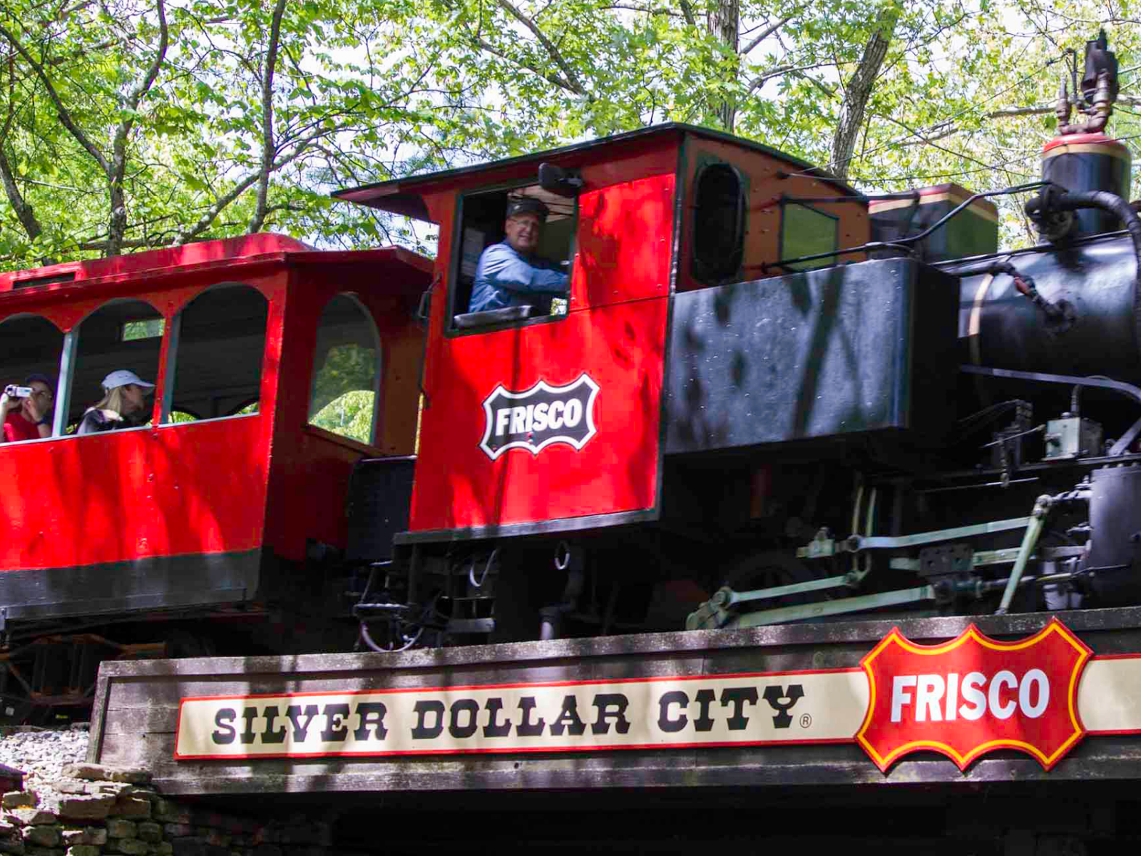 Silver Dollar City's Frisco steam train carrying passengers through the woods at the park in Branson, Missouri