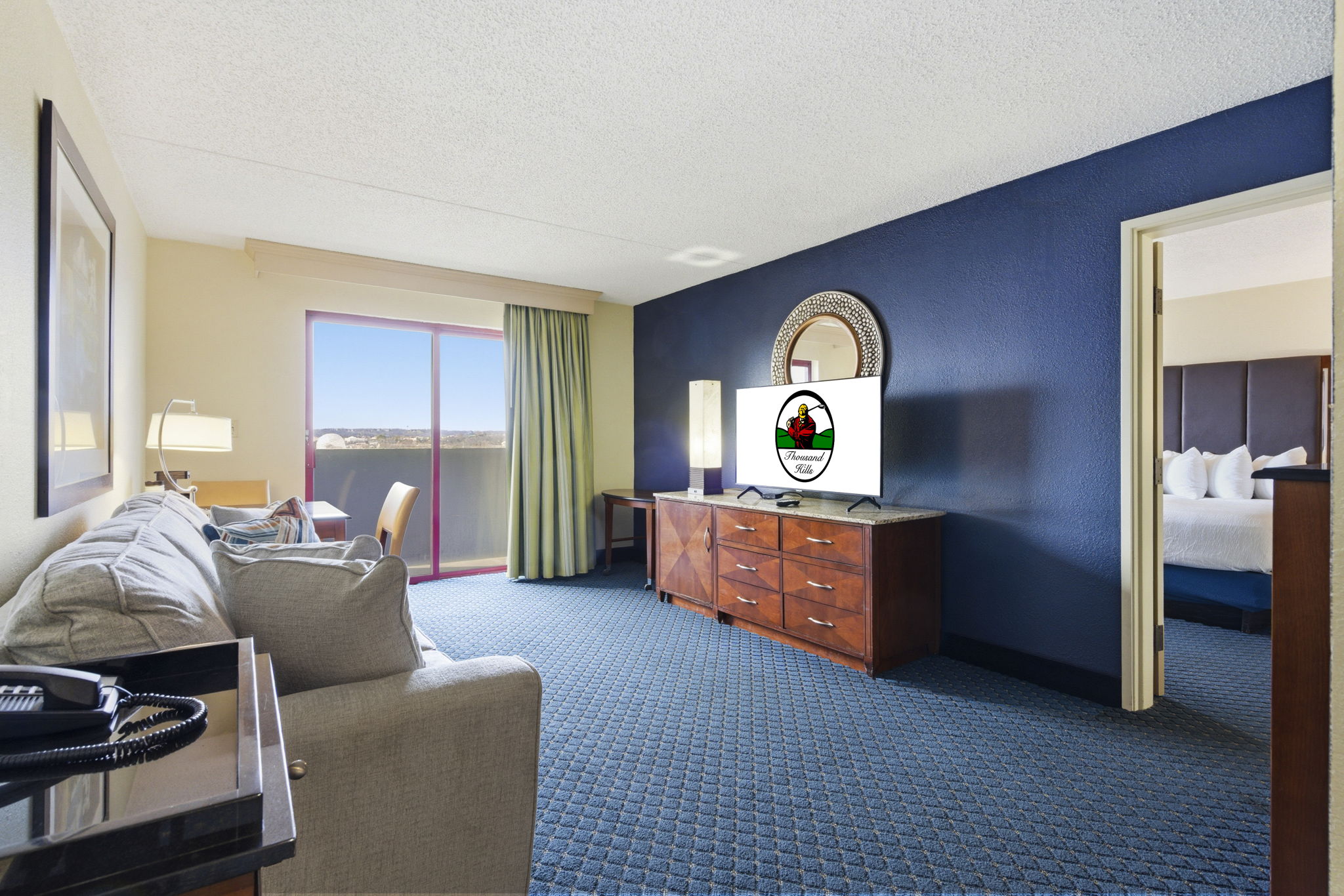 Living area and adjoining bedroom of a suite at Thousand Hills Resort Hotel on South Wildwood Drive in Branson, Missouri