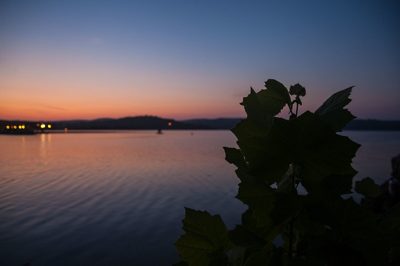 Sunset over Table Rock Lake near Branson, Missouri, with boat lights on the far shoreline