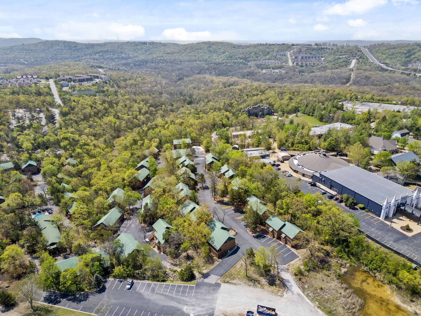 drone shot of cabins in mountains